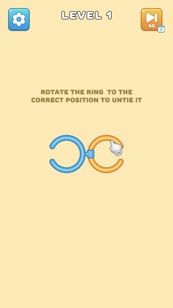 Rings Untie Level 1 with a hand guiding the orange ring toward the clip on a blue ring